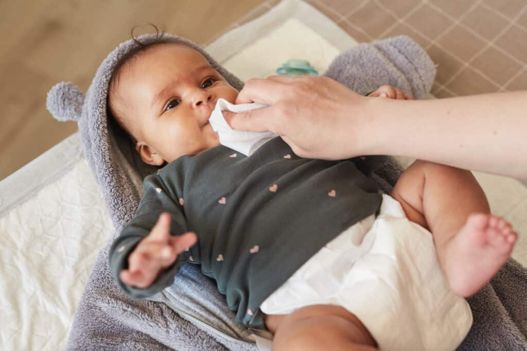 Mother Dressing Baby on Changing Table