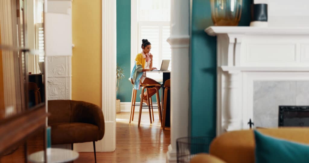 doorway-laptop-and-thinking-with-woman-in-home-of-2026-03-25-09-00-33-utc